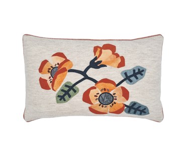 Rectangular shaped cushion with applique flowers in orange tones with plain backing and orange piping