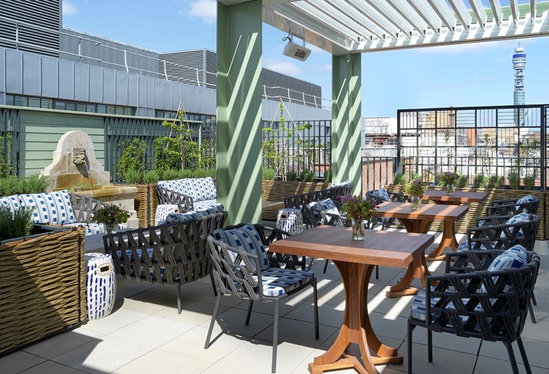 A view of the Roof Terrace the top floor at 9-11 Richmond Buildings featuring lounge seating, occasional tables and views over the Soho skyline.