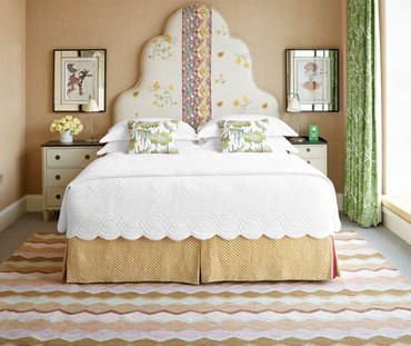 Scalloped edges border crisp, concentric channels of stitching, comforting, cottony and cozy, evoking simpler more innocent days.
In situ bedroom image of bedspread