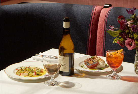A selection of dishes on a table including raw, marinated scallops, salted cucumber, red chilli, lemon and rosemary as well as buffalo mozzarella, grilled yellow peach, cured pork collar, basil