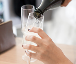 Champagne is being poured into a Champagne flute