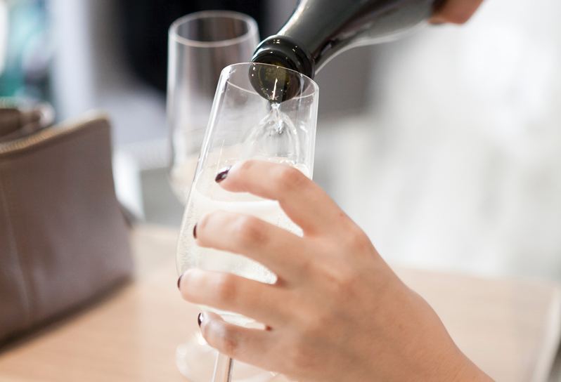 Champagne is being poured into a Champagne flute