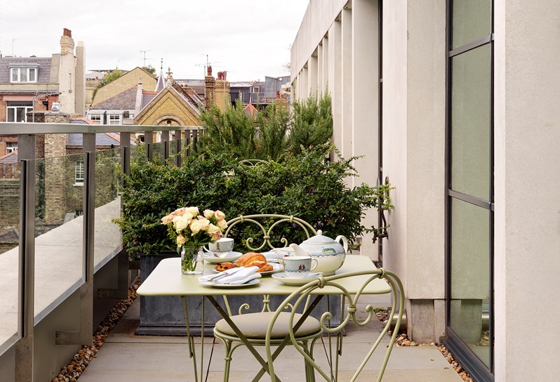 A Luxury Junior Terrace Suite's outdoor terrace with a table and chairs at Ham Yard Hotel