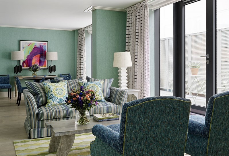 A seating area with outdoor terrace in a One Bedroom Apartment at One Denman Place
