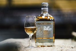A bottle of Bruichladdich whisky with a tasting glass