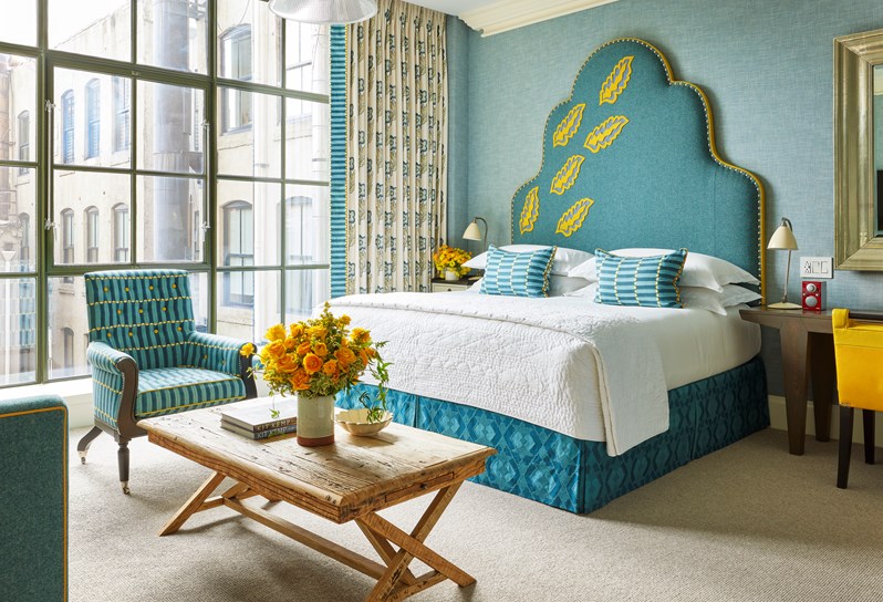 A blue and yellow bedroom scheme at Crosby Street Hotel in New York