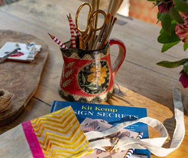 Design secrets book on table, surrounded by crafting materials