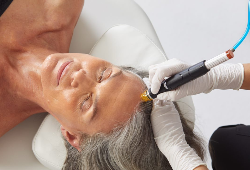 A person receiving a HydraFacial treatment