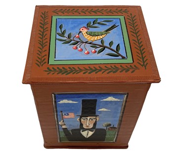 A view from above of the brown President box, showing the bird illustration in shades of green, ochre, and pink.
