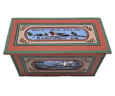 The view from above of the The "Remember Me Box" , hand-painted with the "When this you see remember me" and illustrated with a simple bird in black, white and red, on an branch of an oak tree, on a blue and brown background.