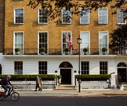 An exterior shot of the Dorset Square Hotel face on from the other side of the street, showing the entrance to The Potting Shed Restaurant and Bar on the right and Union Jack blowing in the wind