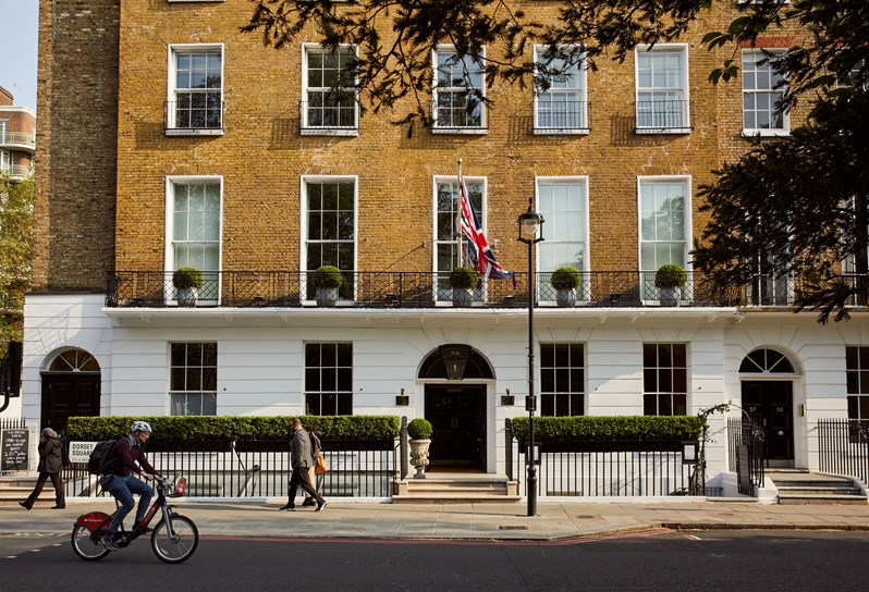 An exterior shot of the Dorset Square Hotel face on from the other side of the street, showing the entrance to The Potting Shed Restaurant and Bar on the right and Union Jack blowing in the wind