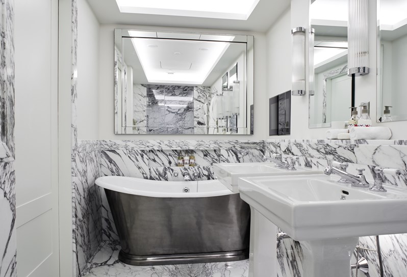 The bathroom with roll top bath in the Meadow Suite at Crosby Street Hotel