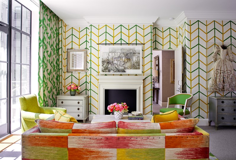 The living room area of the Meadow Suite at Crosby Street Hotel with a door opening into its adjoining room
