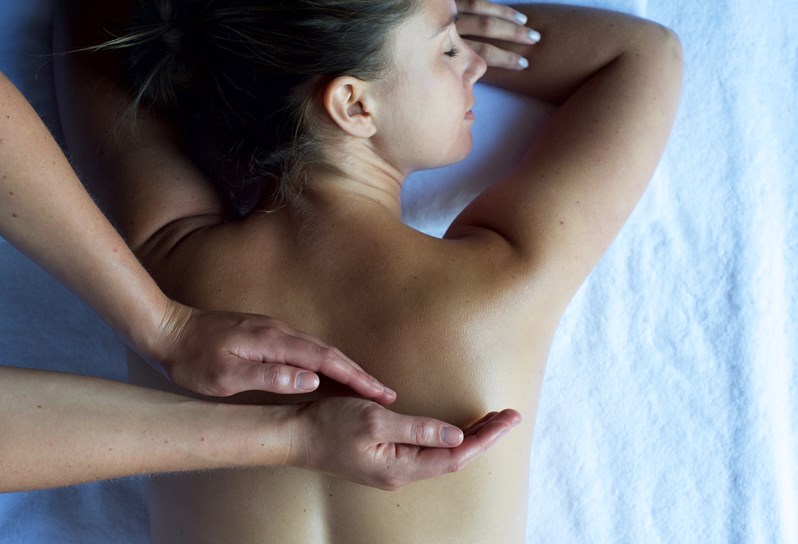 A woman enjoys a back massage