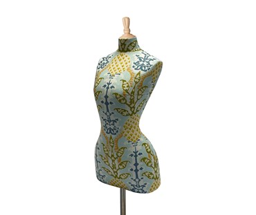 A side view of the Pineapple Mannequin, is a witty take on a Kit's Mannequin, with the pineapples artfully incorporated in this ornate design, in shades of yellows, gold, green and aqua blue, with a pale oak coloured topper and base.