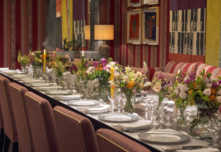 An image of the long dining table set up with flowers in the Sherwood private events room, at The Ham Yard Hotel.