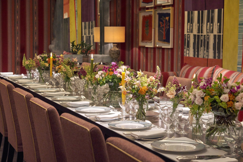 An image of the long dining table set up with flowers in the Sherwood private events room, at The Ham Yard Hotel.