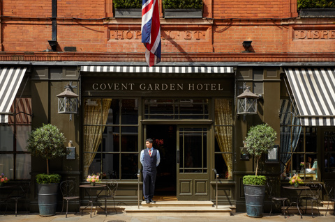 Front on exterior shot of Covent Garden Hotel with a doorman standing in the entrance