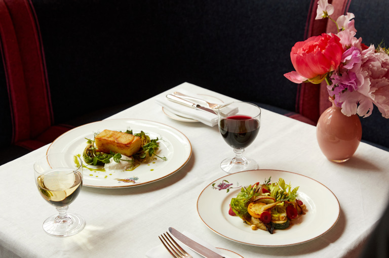 Main courses of roast potato and vegetable salad on plates at Brumus