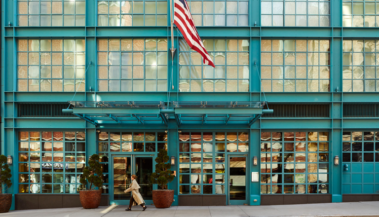 A close up shot of the entrance of the Warren Street Hotel, with the flag.