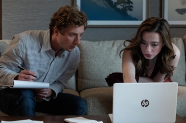 A film still from 'The Social Reckoning' for Firmdale November 2026 Film Club listings, the image shows Mikey Madison and Jeremy Allen Whites characters sitting on a sofa looking at a screen. 