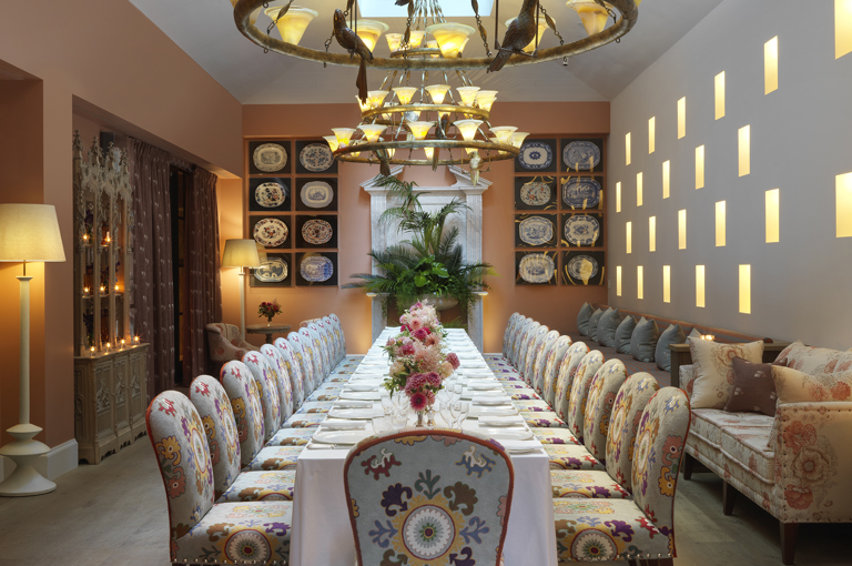 Long dining tables set-up in the Orangery private events room at the Whitby Hotel