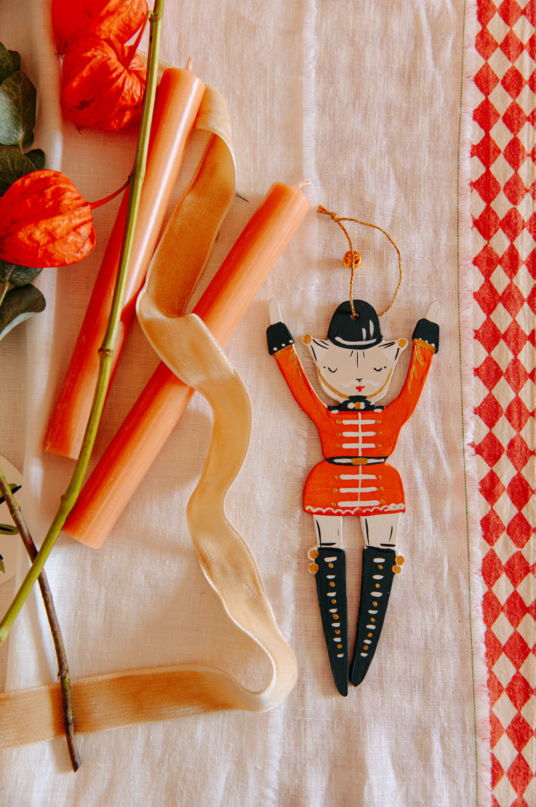 A small soldier Christmas decoration by Alice Mary Lynch laid on a table