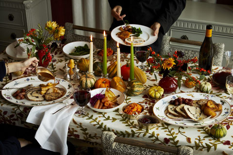 Wide shot of a Thanksgiving dining table with guests