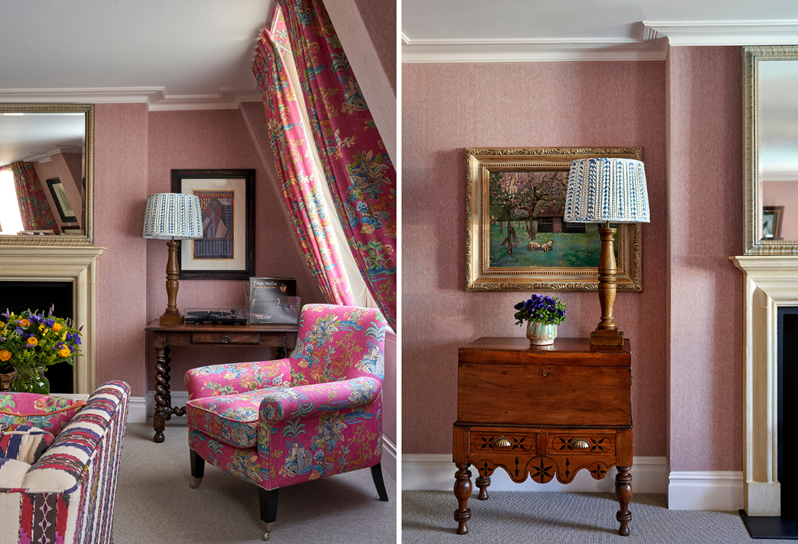 Two stiches photo in one bedroom suites on the left an armchair sits in the corner of the room with a log fireplace to the left and window and urtains to the right. and an antique chest with a lampshade and a flowervest on it, theres a beautiful frame hanging on the wall.