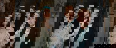 A still from Fackham Hall. Two women and two men dressed in formal period clothing, can be seen looking from a door, out ahead in shock