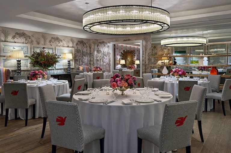 Round dining tables set-up in the Prince private events room at Crosby Street Hotel