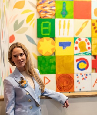 Willow Kemp stands next to a painting at The Whitby Hotel