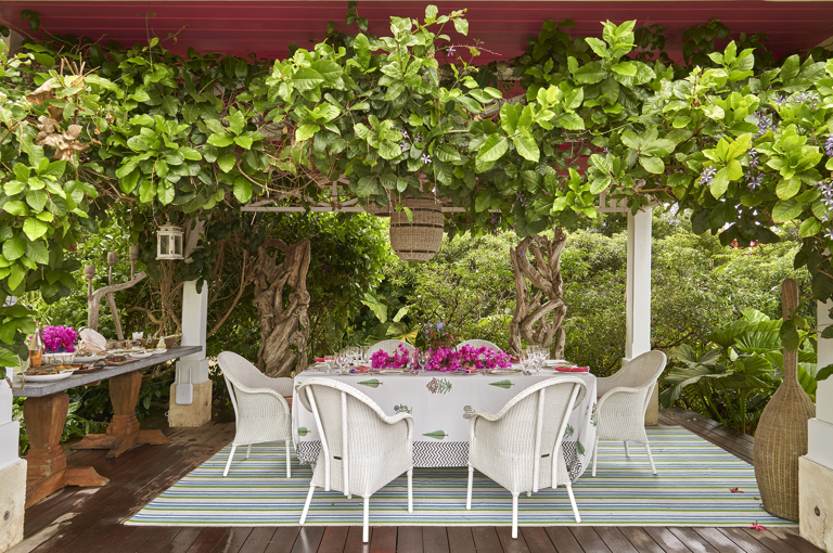 A close up image of the terrace at the side of the pool used for dining. At Rossferry, the Caribbean property manged by Firmdale.