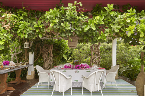 A close up image of the terrace at the side of the pool used for dining. At Rossferry, the Caribbean property manged by Firmdale.