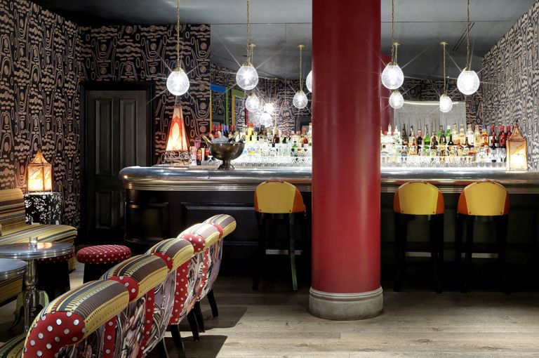 Wide shot of the bar in the Crimson Bar private events room at the Soho Hotel