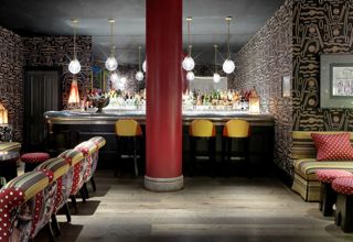 Wide shot of the bar in the Crimson Bar private events room at the Soho Hotel