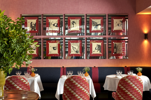 Side shot of Brumus Restaurant dining tables and artwork at Haymarket Hotel