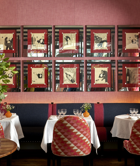 Side shot of Brumus Restaurant dining tables and artwork at Haymarket Hotel
