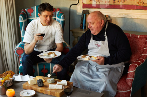 An image of Joe Fox and Eric Charriauxh holding a glass of wine surrounded by different cheeses at The Potting Shed, Dorset Square Hotel