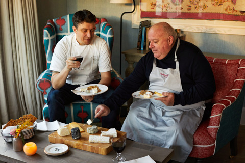 An image of Joe Fox and Eric Charriauxh holding a glass of wine surrounded by different cheeses at The Potting Shed, Dorset Square Hotel