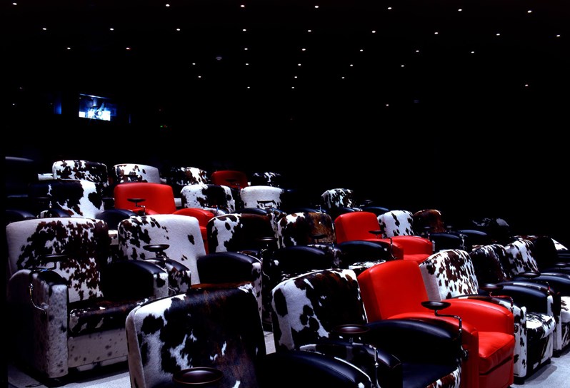 The screening room at Soho Hotel.  Black and white cinema style chairs interspersed with red leather chairs.