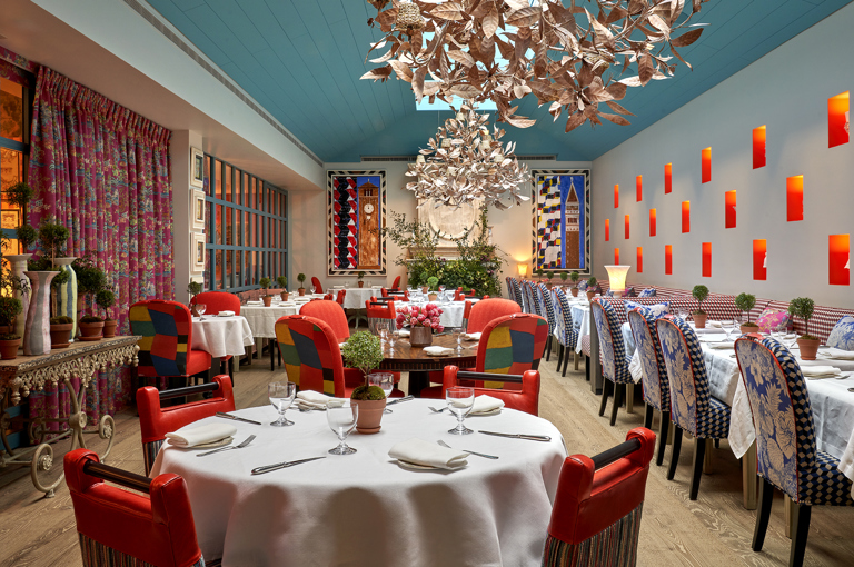 Round and long dining tables set-up in the Orangery private events room at Warren Street Hotel