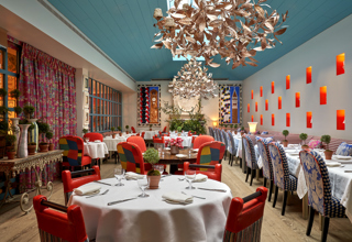 Round and long dining tables set-up in the Orangery private events room at Warren Street Hotel