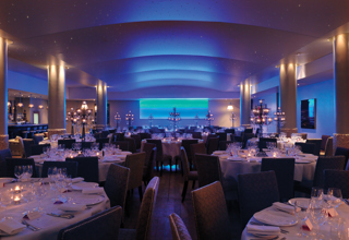 Wide shot of round dining tables in the Swimming pool private events room at Haymarket Hotel