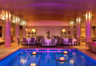 An image of the evening dining set up by the swimming pool at Haymarket Hotel