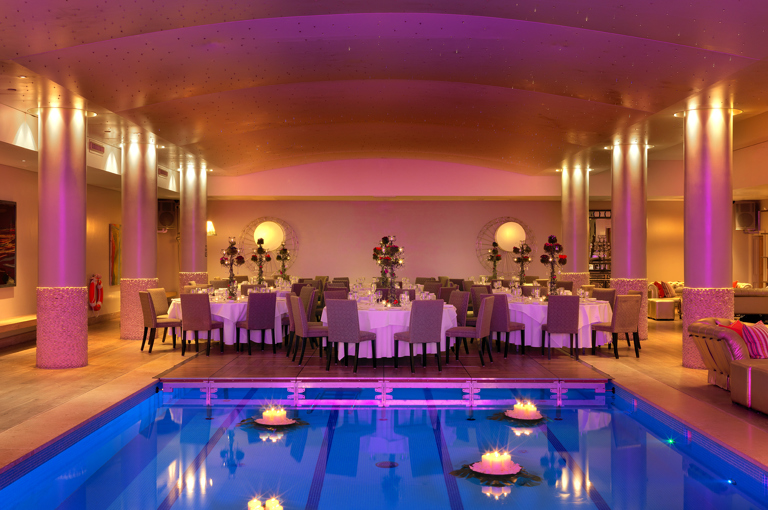An image of the evening dining set up by the swimming pool at Haymarket Hotel