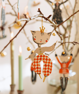 A Christmas decoration by Alice Mary Lynch hanging on a small branch