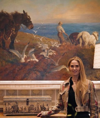 Firmdale Art Ambassador and Design Director Willow Kemp standing in front of a large painting in the Drawing Room at Ham Yard Hotel