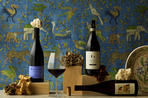 Wide shot of three bottles of wine on a table for Firmdales journal article about pairing wine with mushrooms.